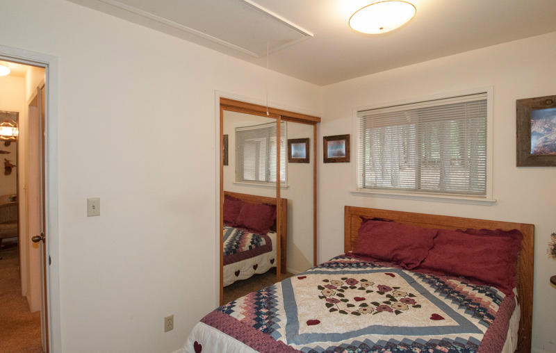 293 Cedar Road Trinity Center, CA 96091 - Photo 11 of 14 a view of a bedroom with wooden floor and a window