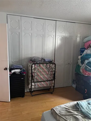 a bedroom with a bed and a mirror