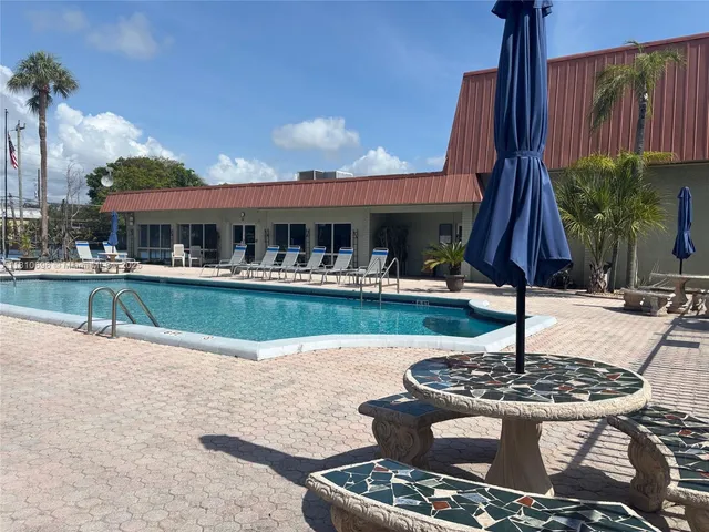 a view of a house with swimming pool and a sitting area