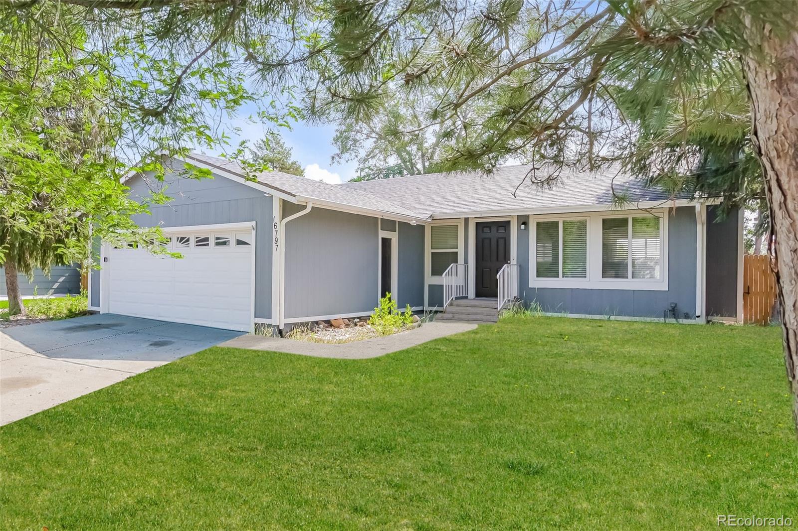 16797 East Mansfield Circle Aurora, CO 80013 - Photo 1 of 17 a view of a house with a yard and large tree