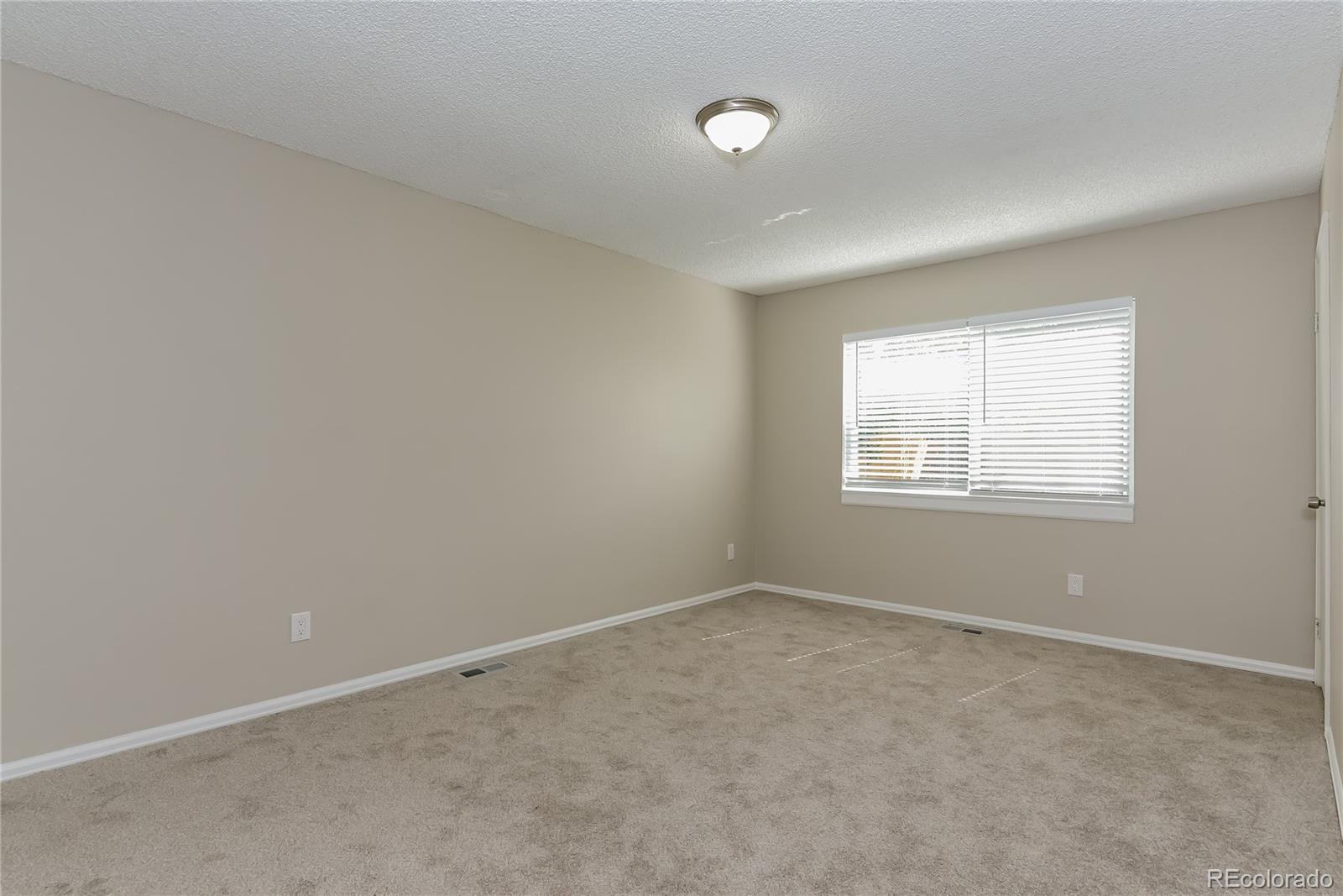 16797 East Mansfield Circle Aurora, CO 80013 - Photo 11 of 17 an empty room with windows