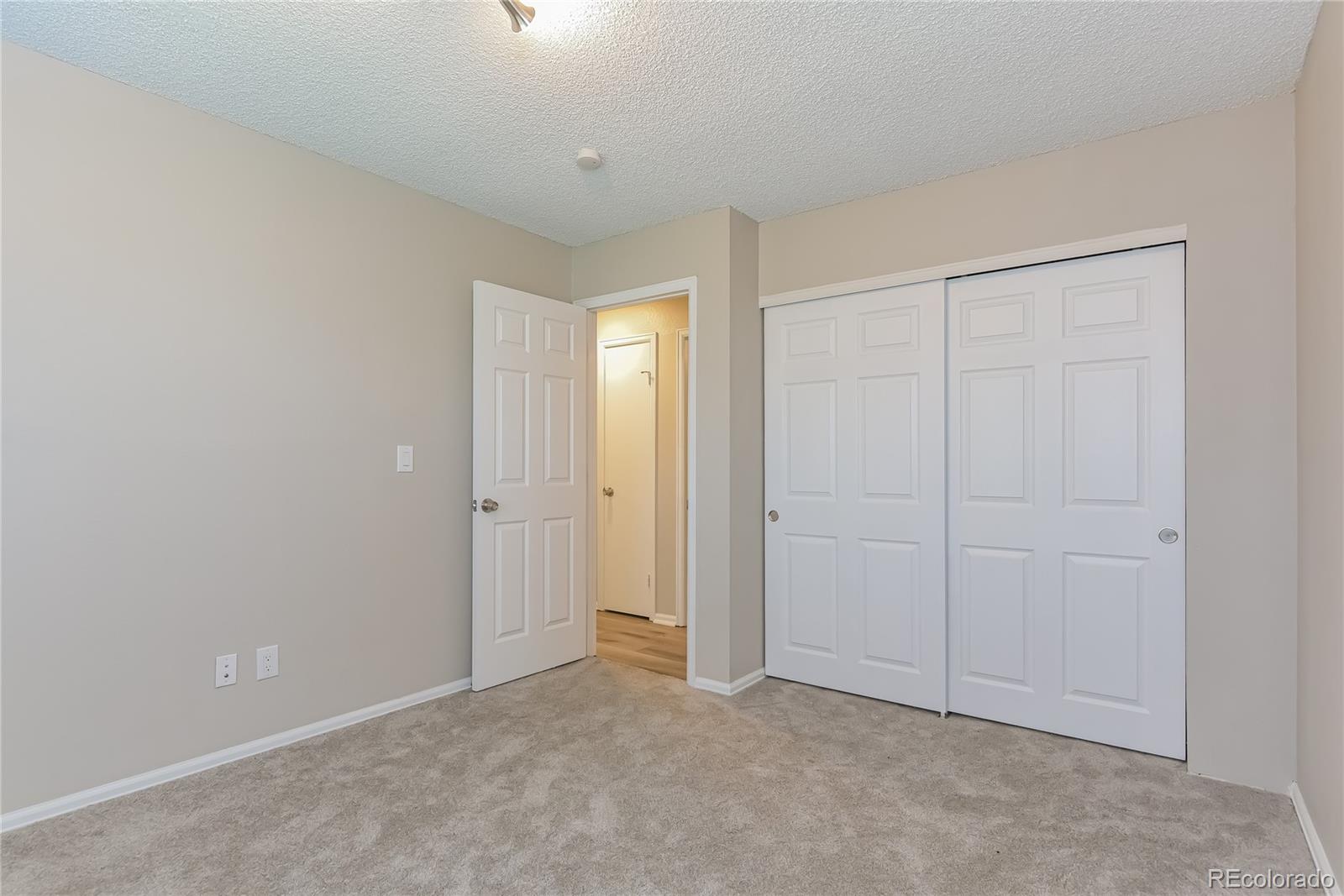 16797 East Mansfield Circle Aurora, CO 80013 - Photo 12 of 17 a view of an empty room and closet area