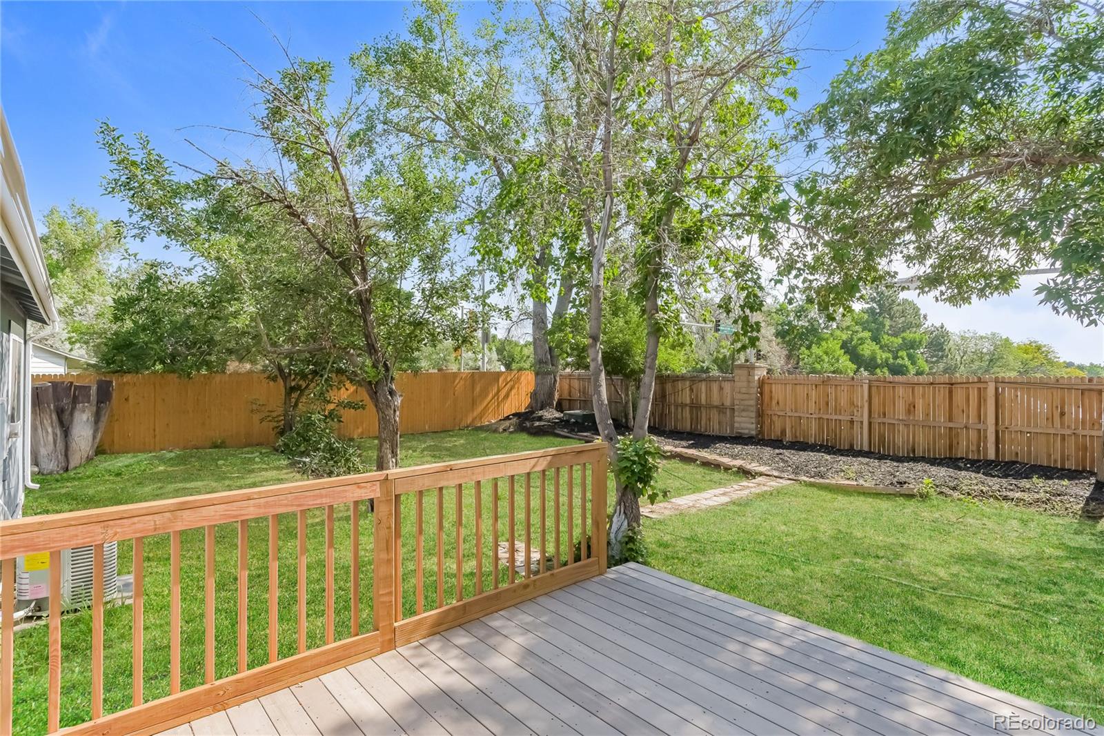 16797 East Mansfield Circle Aurora, CO 80013 - Photo 15 of 17 a view of a deck with a yard and wooden fence