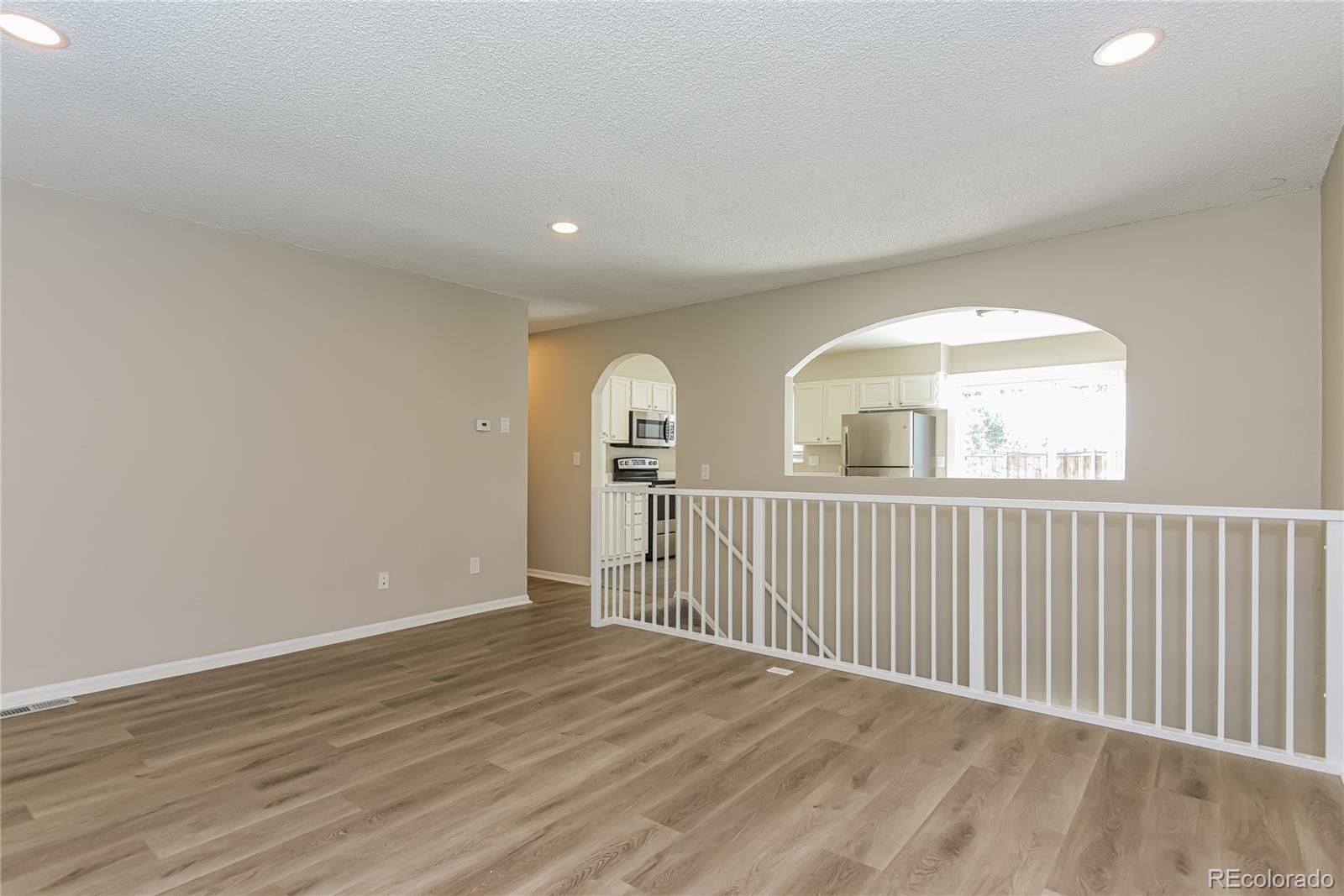 16797 East Mansfield Circle Aurora, CO 80013 - Photo 3 of 17 a view of entryway with wooden floor