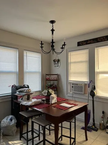 a view of a dining room with a table and chairs