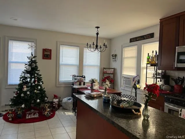 a kitchen with a large window and a dining table