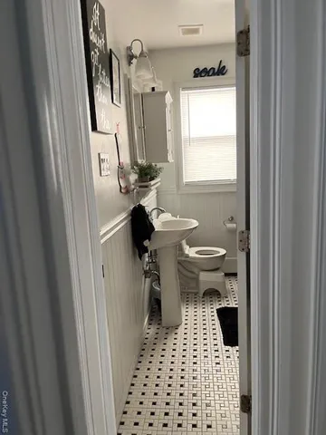 a bathroom with a sink a toilet and a shower