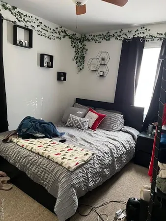 a bedroom with bed and a window