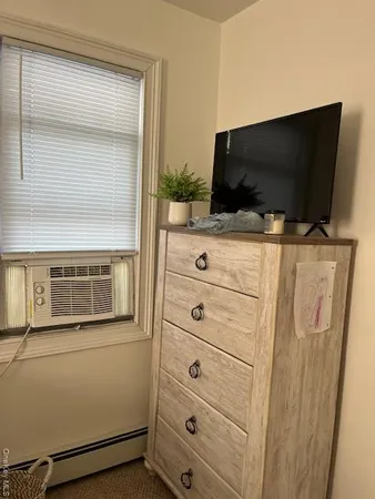 a view of a livingroom with an empty space and a flat screen tv