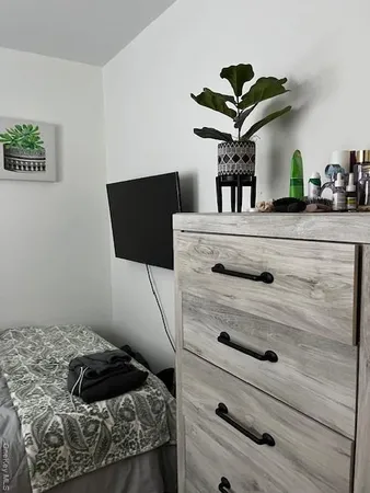 a bedroom with a bed and a chandelier