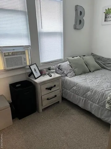 a bed room with a bed and a window
