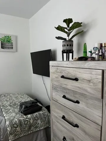 a bedroom with a bed and a chandelier