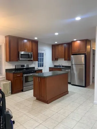 a kitchen with stainless steel appliances granite countertop a refrigerator stove microwave and sink