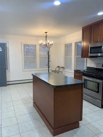a kitchen with stainless steel appliances a sink and a stove