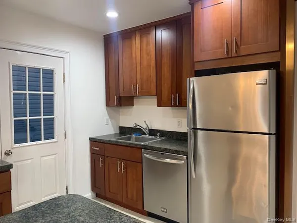 a white refrigerator freezer sitting in a kitchen