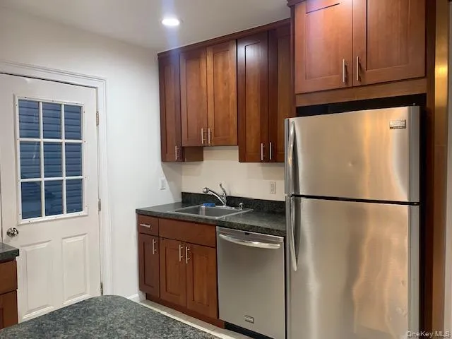 a white refrigerator freezer sitting in a kitchen