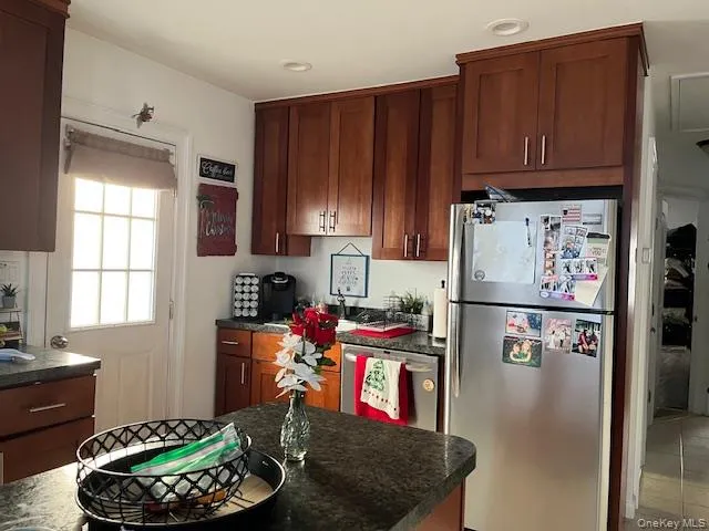 a kitchen with a refrigerator and a stove