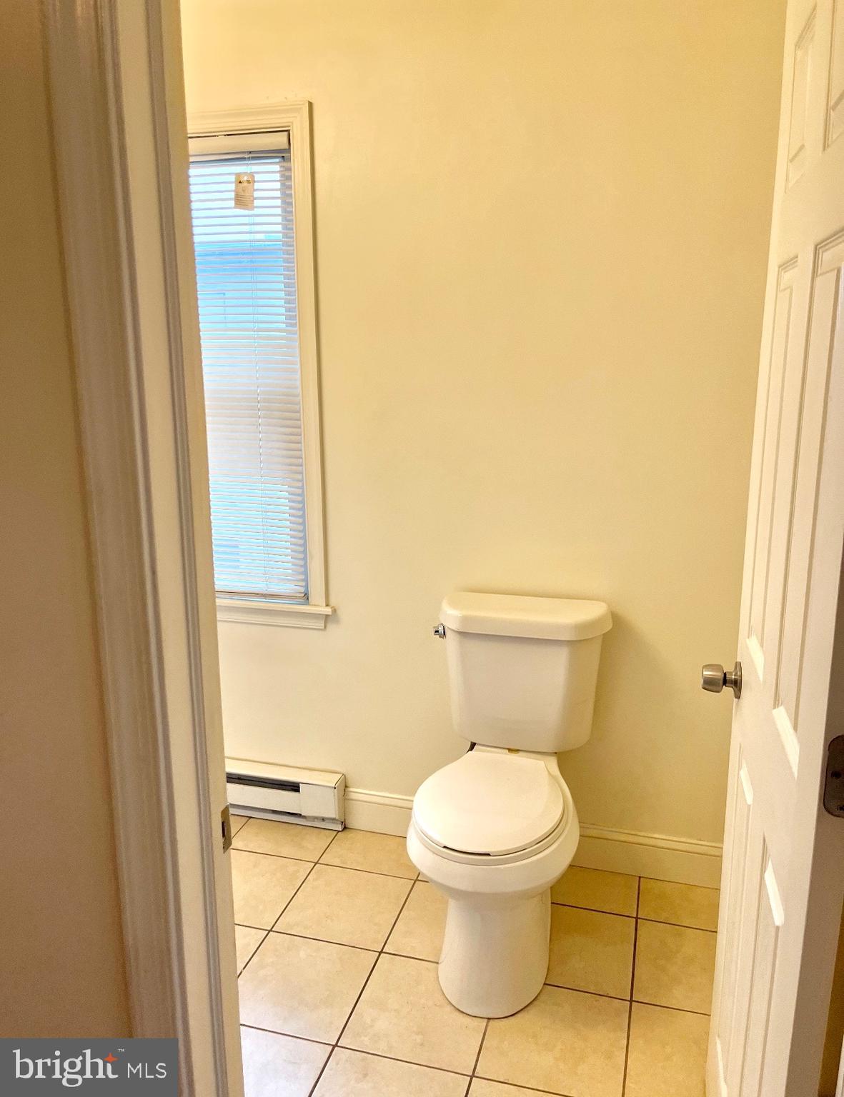 2213 Wakeling Street Philadelphia, PA 19137 - Photo 8 of 8 a white toilet sitting next to a shower