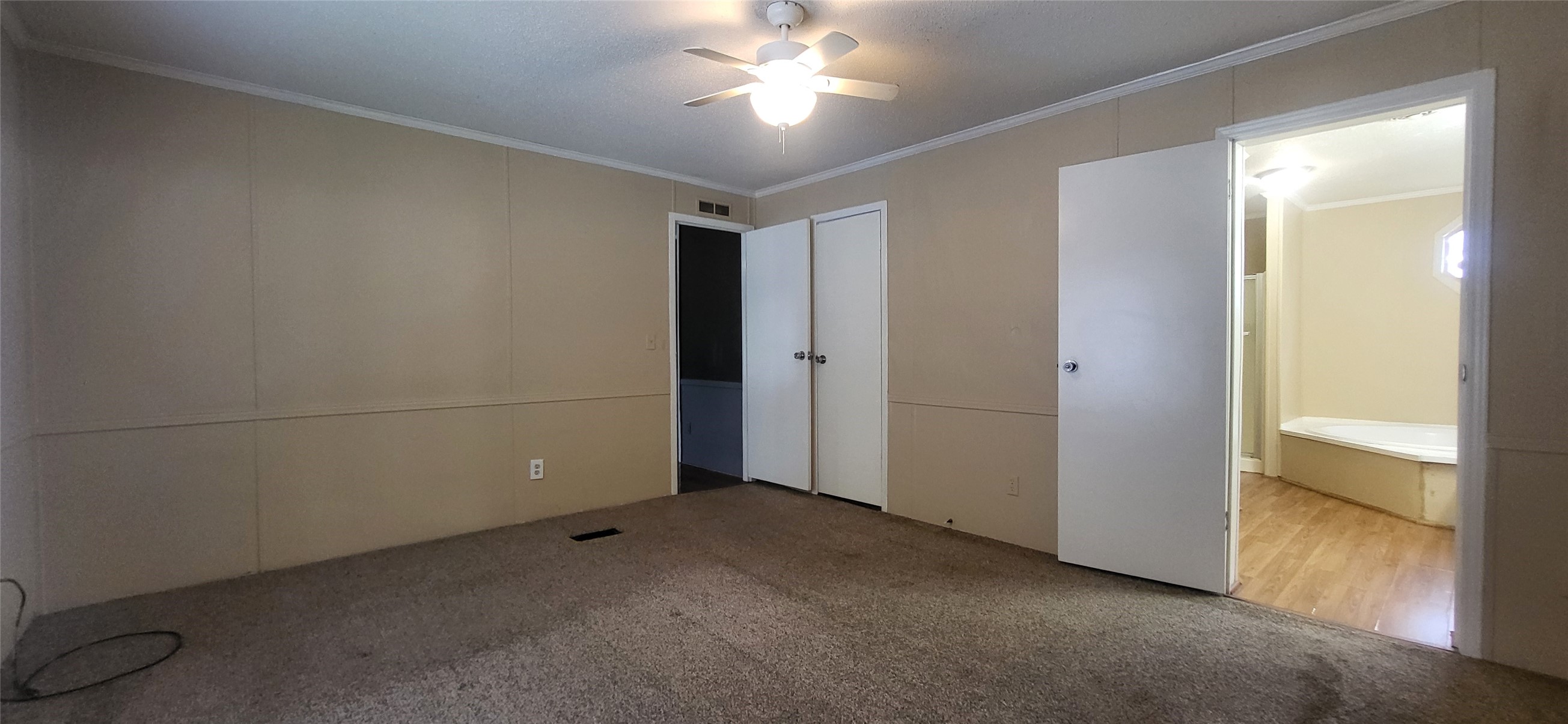16711 Lake Circle Conroe, TX 77302 - Photo 12 of 20 a view of a room with a ceiling fan and a window