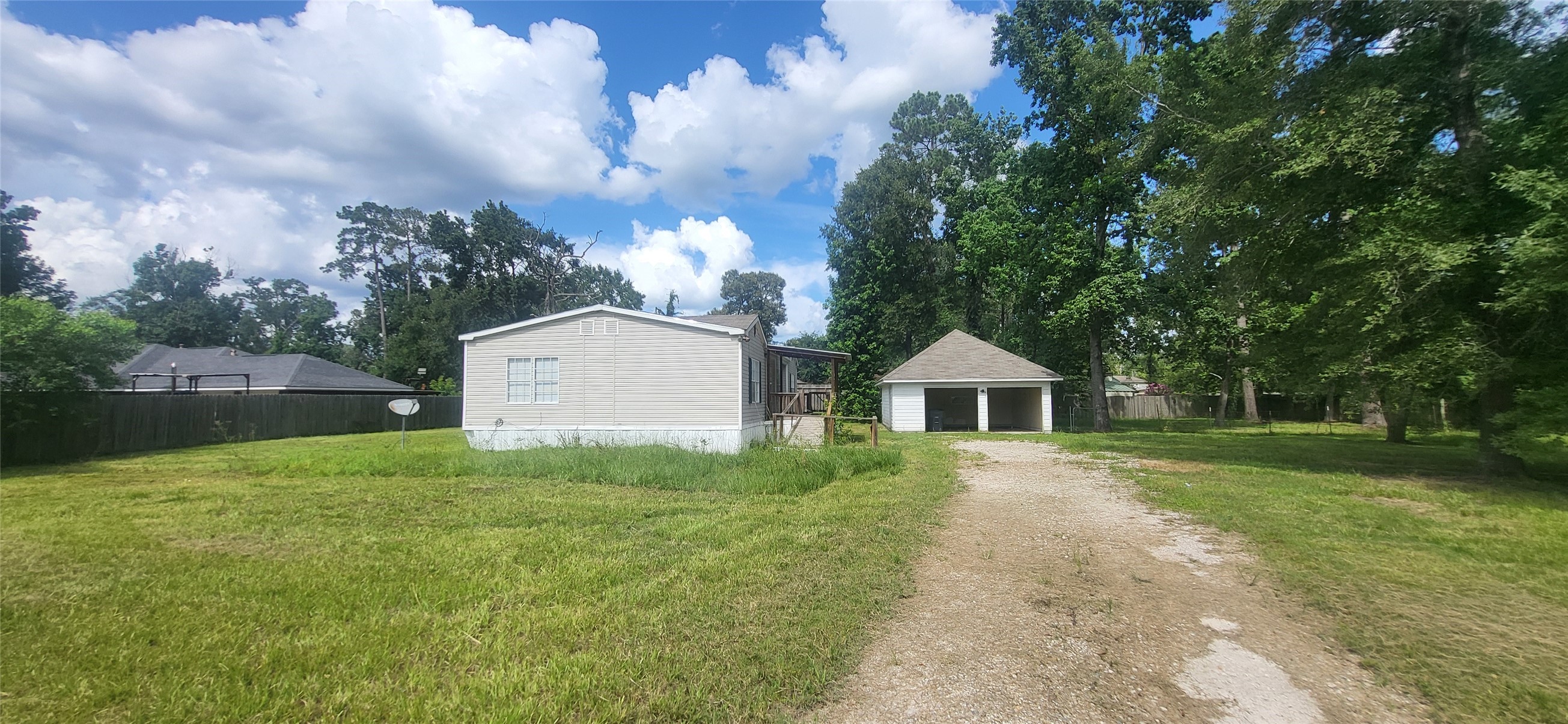 16711 Lake Circle Conroe, TX 77302 - Photo 19 of 20 a front view of a house with a yard and trees