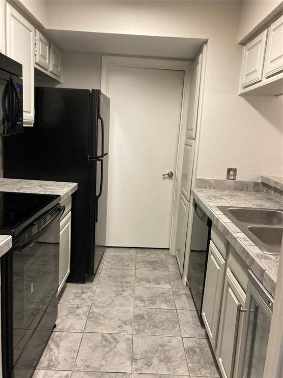 18240 Midway Road, Unit 905 Dallas, TX 75287 - Photo 6 of 15 Galley Kitchen w wine cooler and connected laundry room/half bathroom