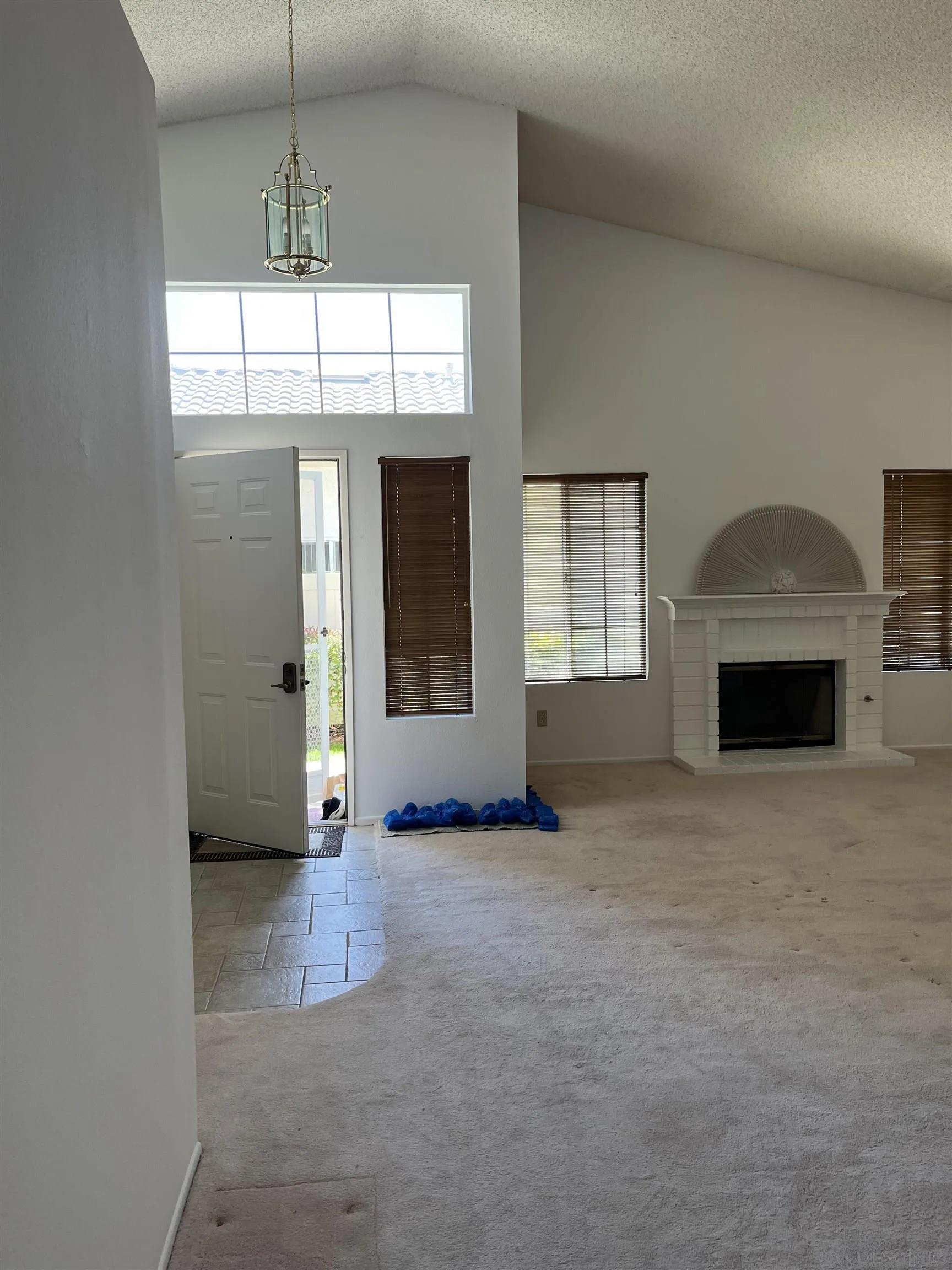 857 Pauma Valley Road Banning, CA 92220 - Photo 6 of 20 an empty room with windows and fireplace