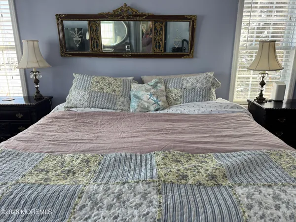 a bedroom with a bed and a television
