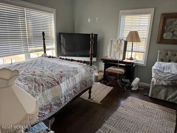 a bedroom with bed couch and window