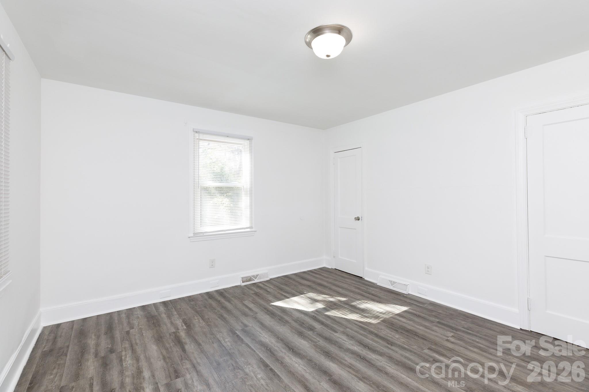 723 Finley Road Rock Hill, SC 29730 - Photo 14 of 22 an empty room with wooden floor and window