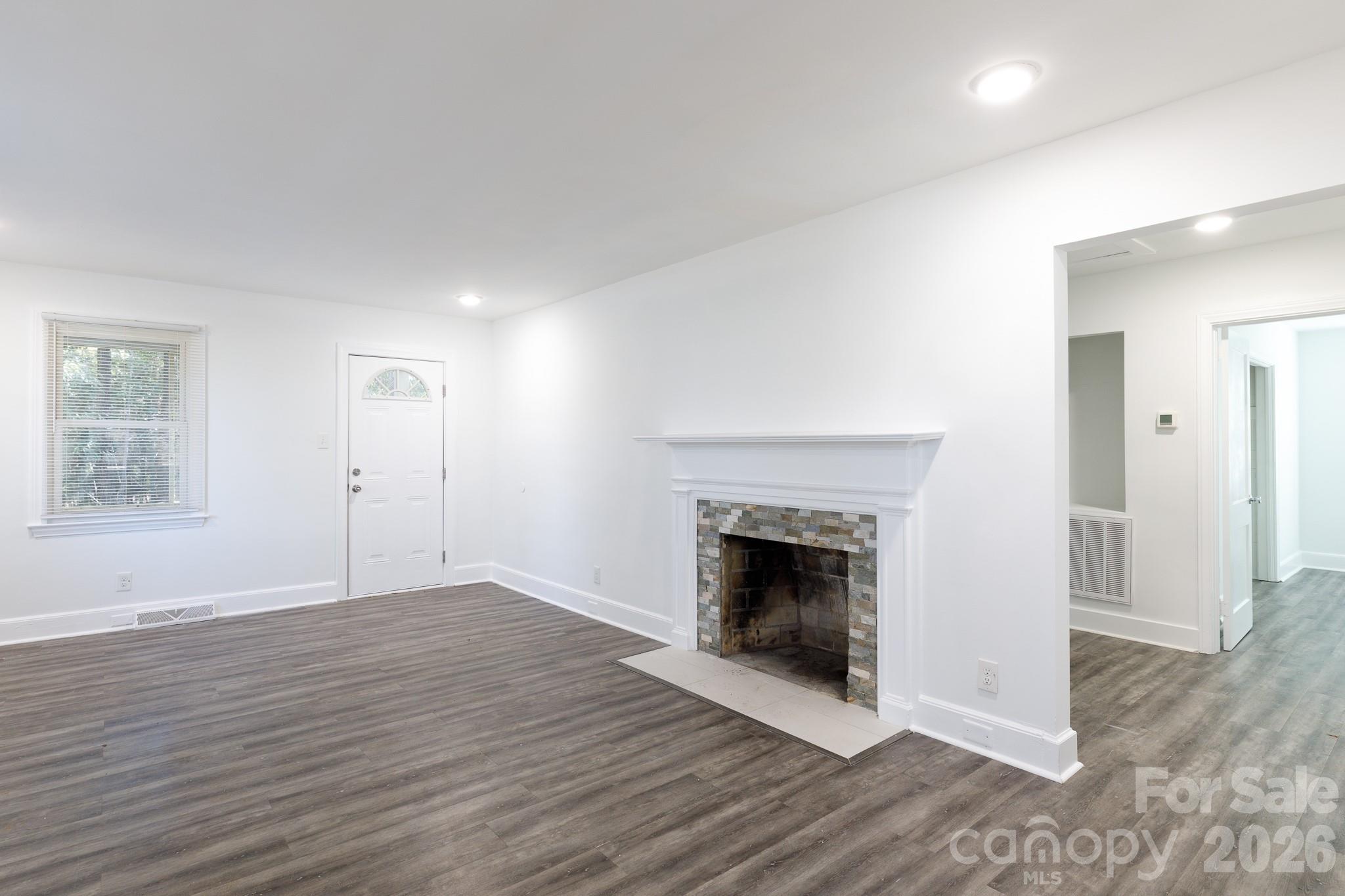 723 Finley Road Rock Hill, SC 29730 - Photo 2 of 22 an empty room with wooden floor and fireplace