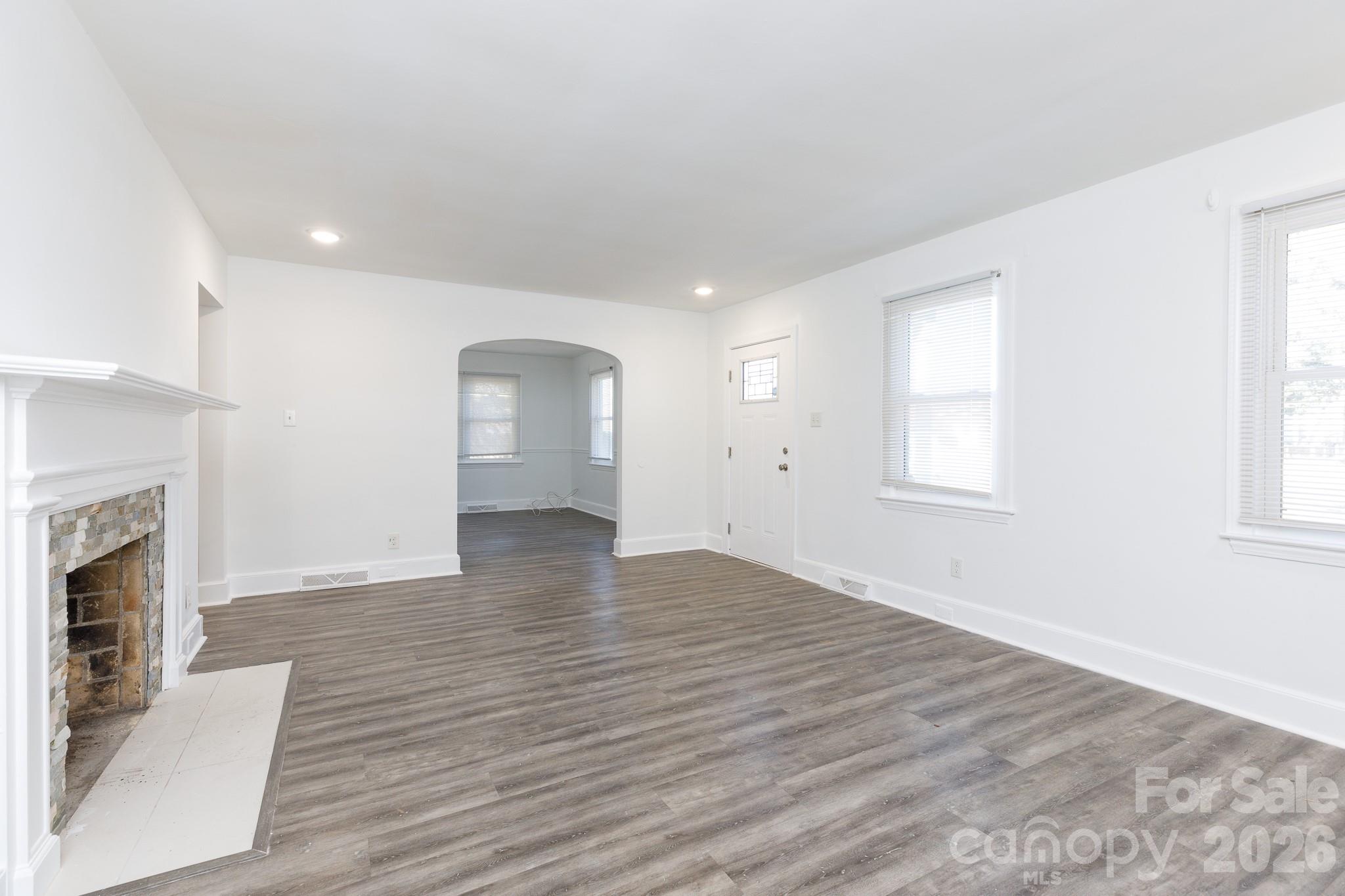 723 Finley Road Rock Hill, SC 29730 - Photo 3 of 22 an empty room with wooden floor fireplace and windows