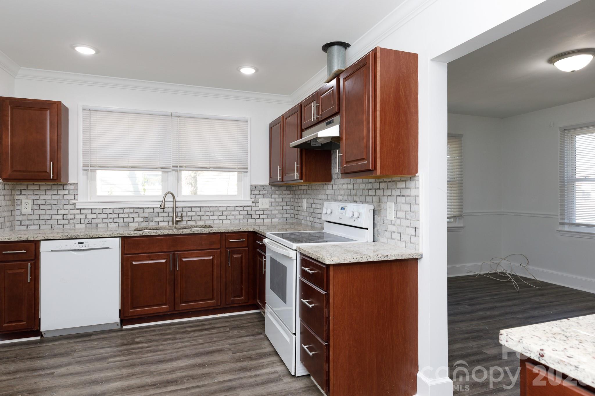 723 Finley Road Rock Hill, SC 29730 - Photo 8 of 22 a kitchen with stainless steel appliances granite countertop wooden cabinets a stove top oven a sink and dishwasher