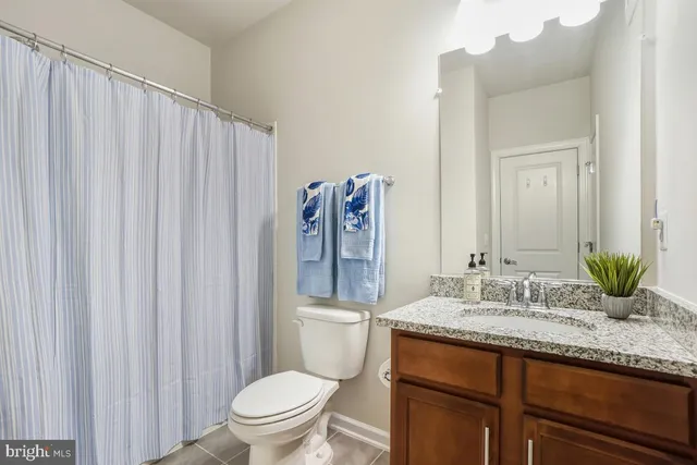 a bathroom with a shower curtain and a bathtub