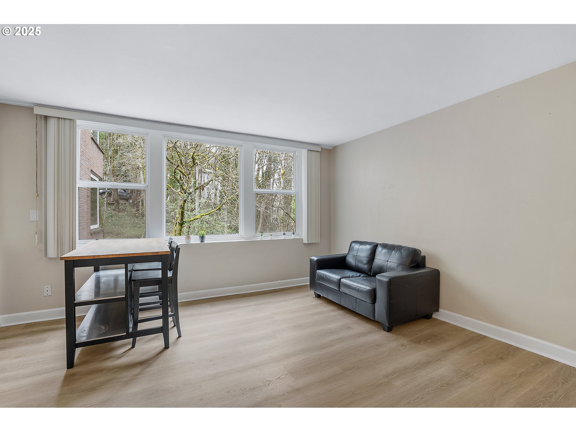 1205 Southwest Cardinell Drive, Unit 704 Portland, OR 97201 - Photo 11 of 23 a living room with furniture and a window