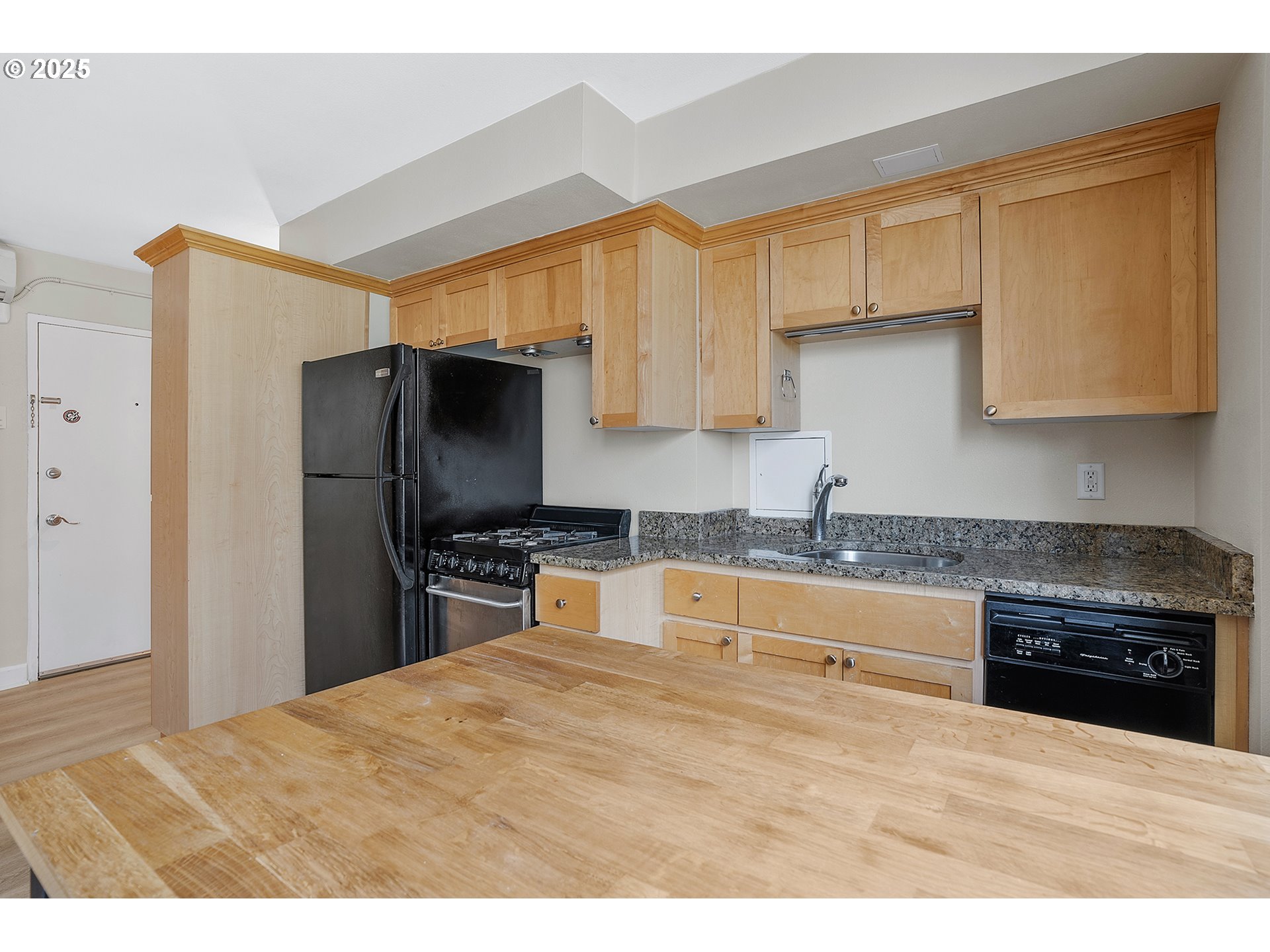 1205 Southwest Cardinell Drive, Unit 704 Portland, OR 97201 - Photo 14 of 23 a kitchen with granite countertop a stove a sink and a refrigerator