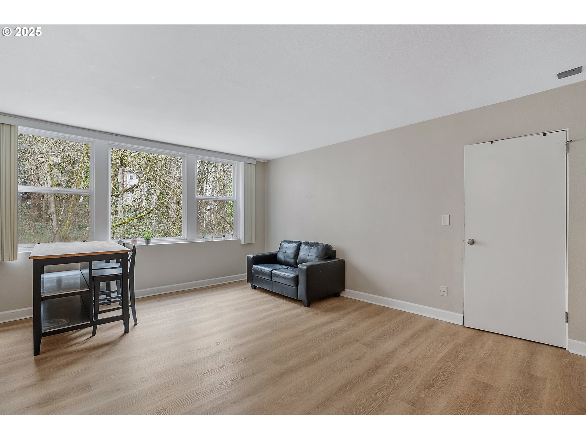 1205 Southwest Cardinell Drive, Unit 704 Portland, OR 97201 - Photo 6 of 23 a living room with furniture and a window
