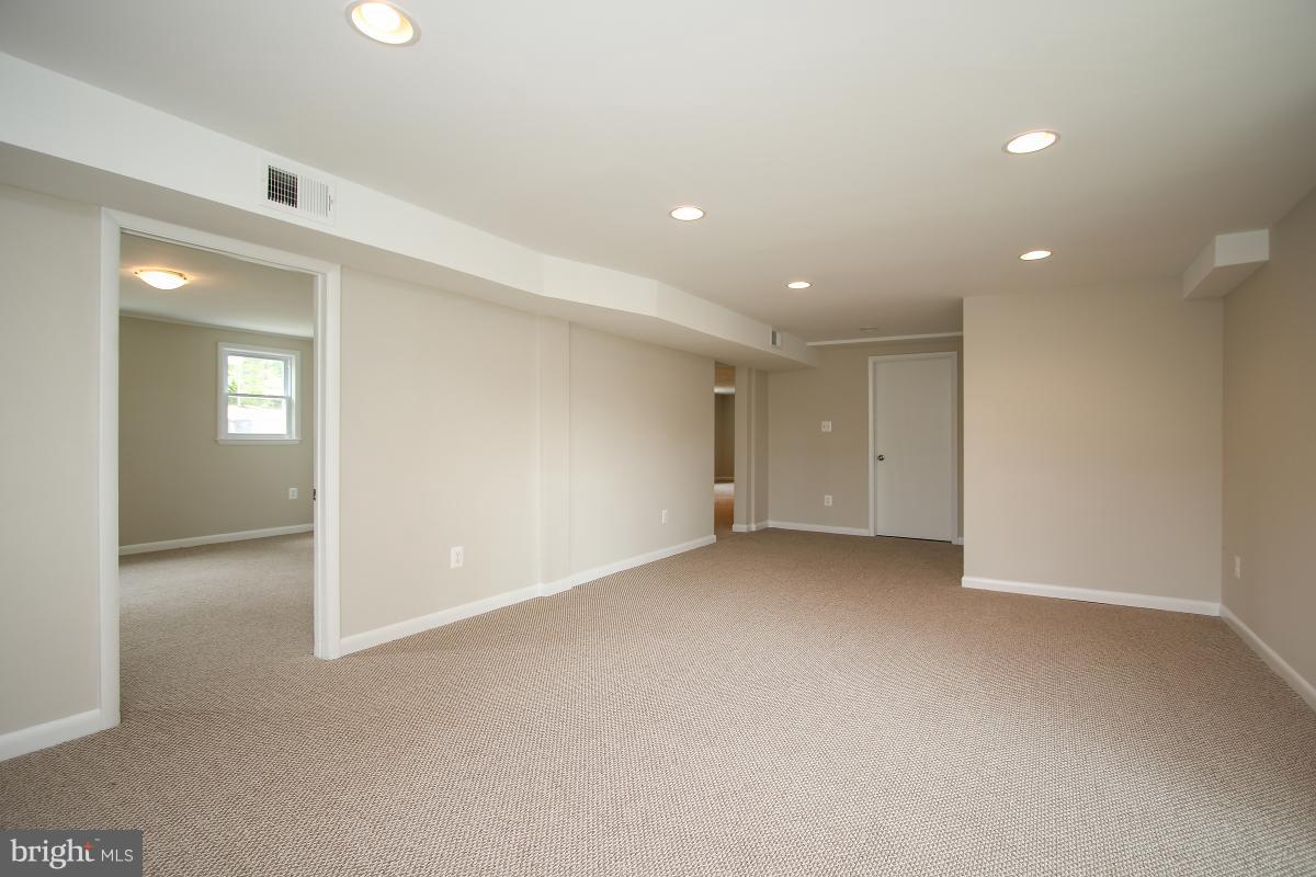 6903 Presley Road Lanham, MD 20706 - Photo 25 of 28 an empty room with windows and entrance to other room