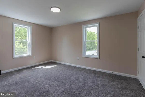 a view of an empty room and a window