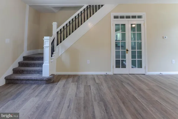 a view of an entryway with wooden floor