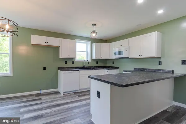 a kitchen with a sink window and cabinets