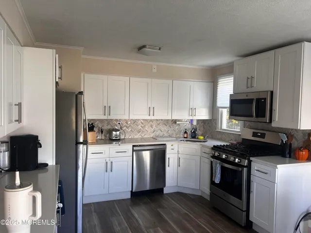 a kitchen with a sink stove and microwave