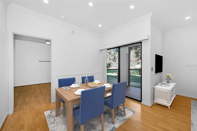 a view of an empty room with a window and a kitchen