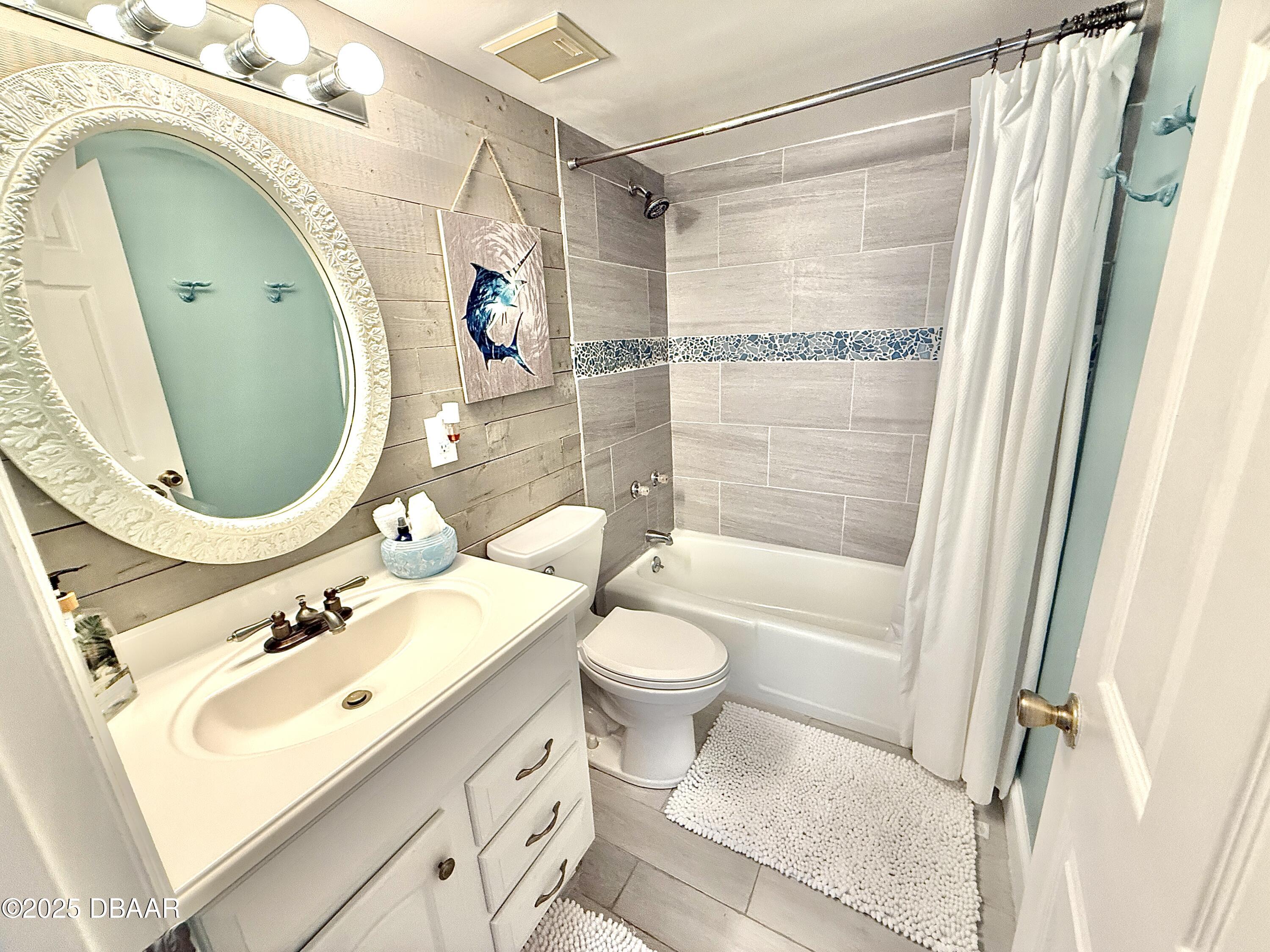 30 Inlet Harbor Road, Unit 606 Ponce Inlet, FL 32127 - Photo 27 of 45 a bathroom with a sink mirror vanity and toilet