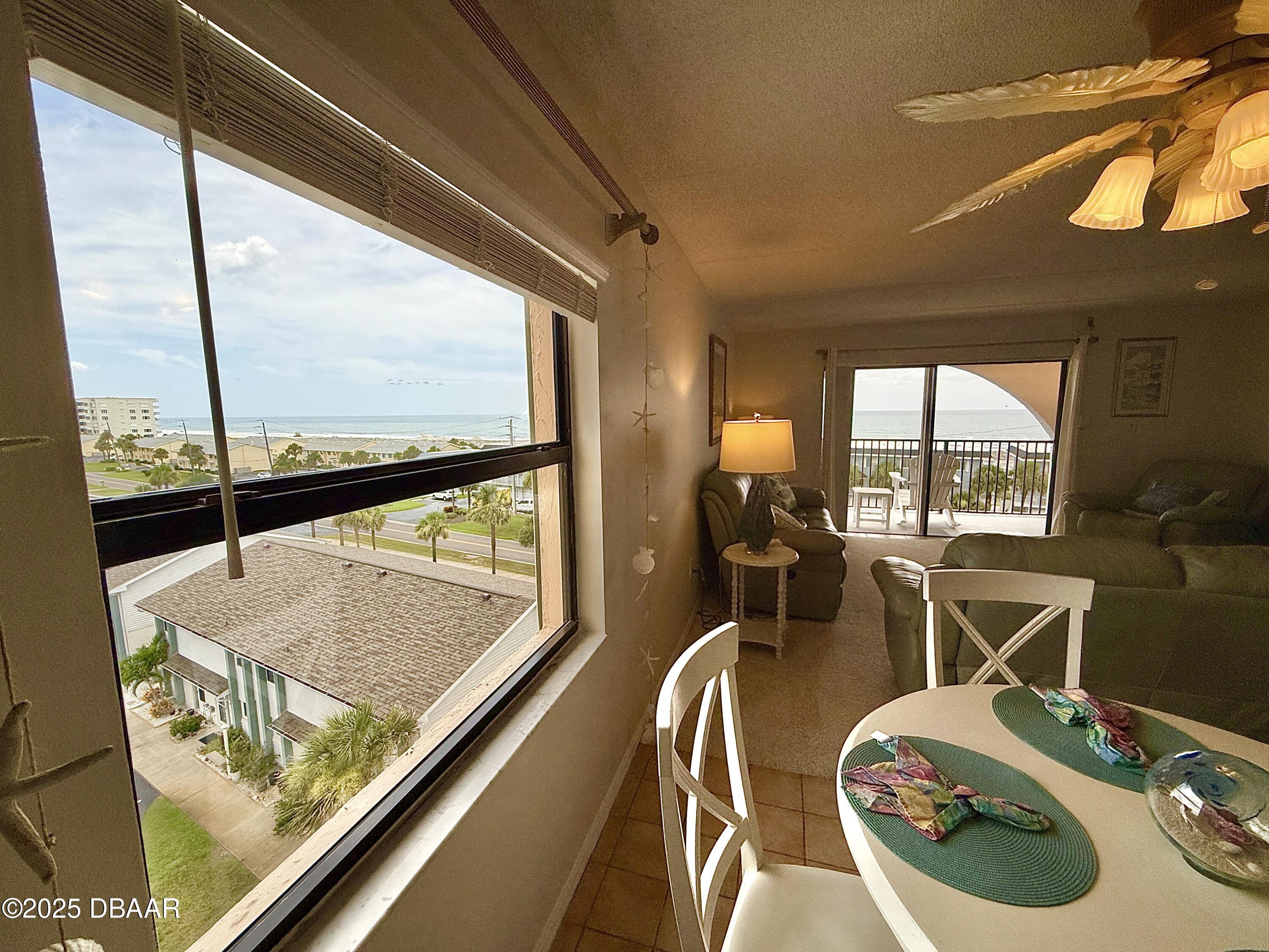30 Inlet Harbor Road, Unit 606 Ponce Inlet, FL 32127 - Photo 35 of 45 a view of a living room with furniture and floor to ceiling window