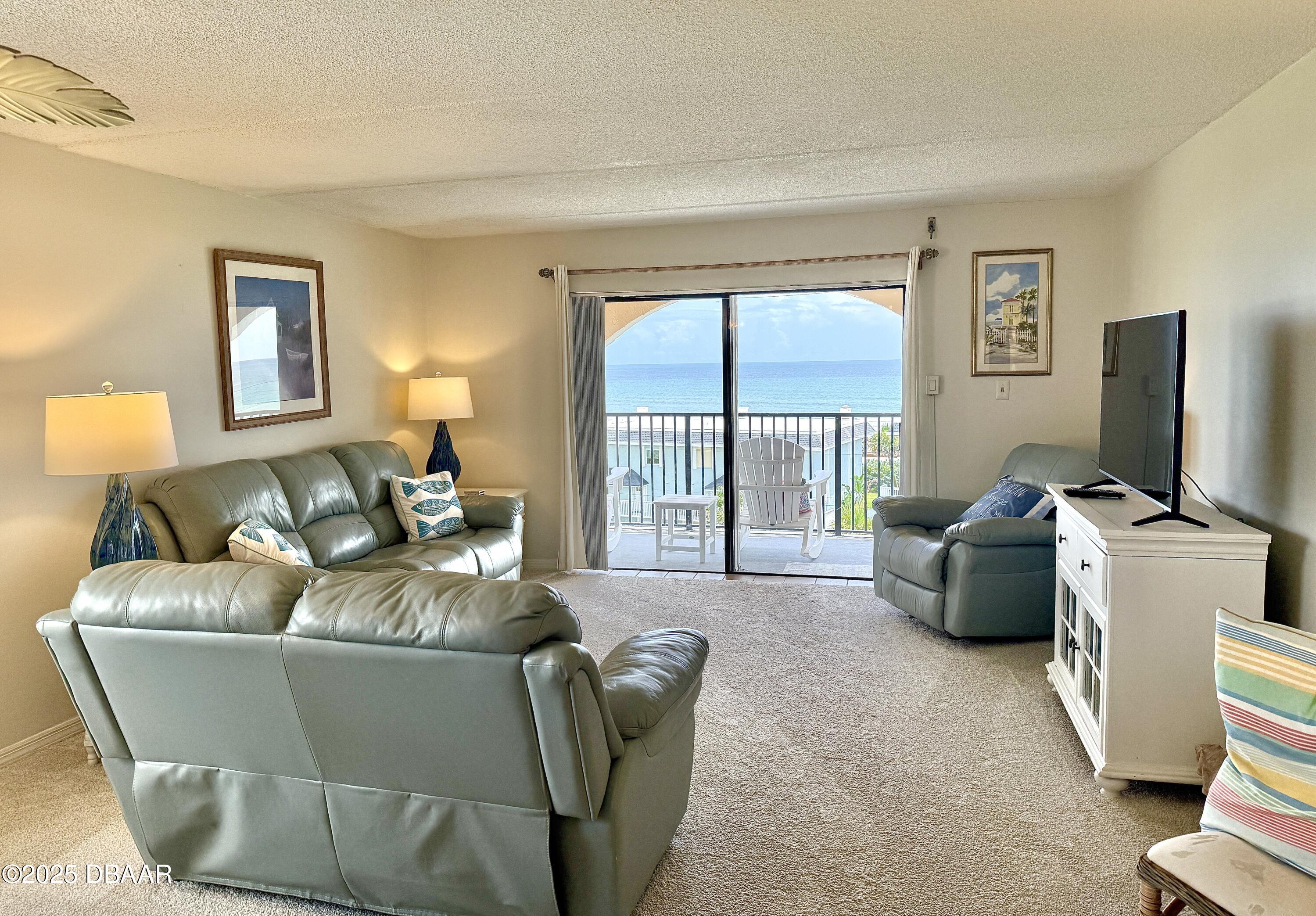 30 Inlet Harbor Road, Unit 606 Ponce Inlet, FL 32127 - Photo 9 of 45 a living room with furniture and a flat screen tv