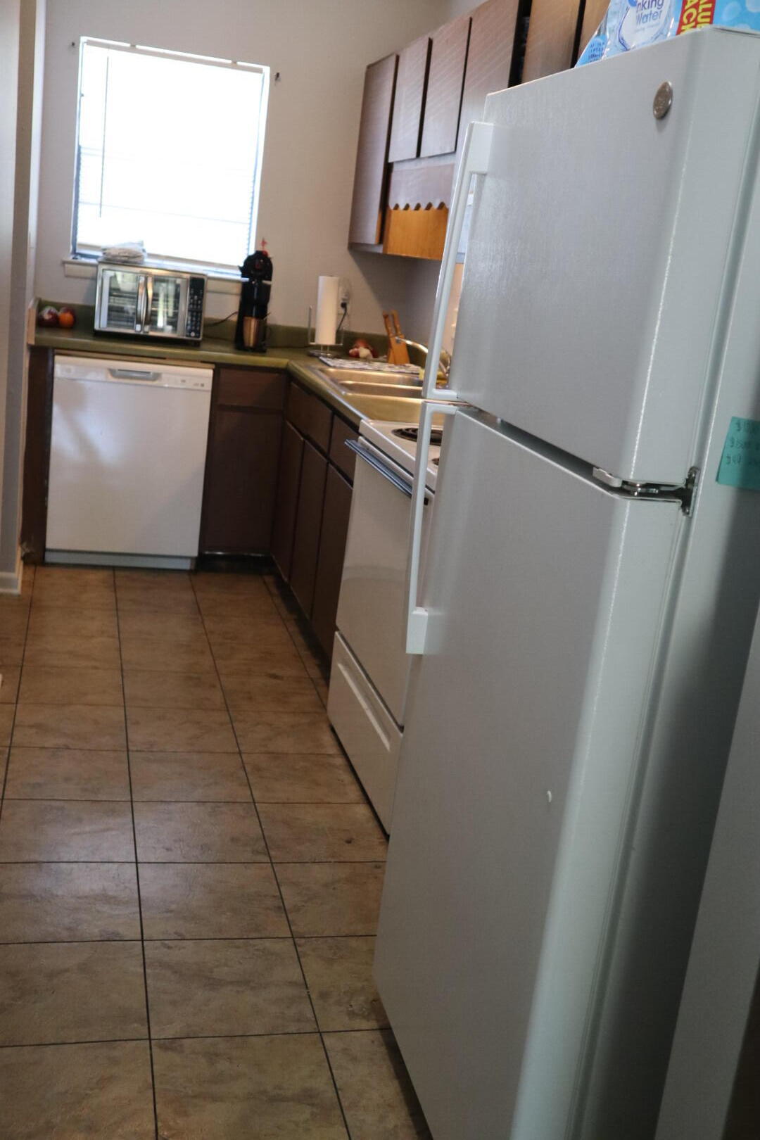40 11th Street, Unit 99 Shalimar, FL 32579 - Photo 7 of 14 a kitchen with a sink a stove top oven and cabinetry