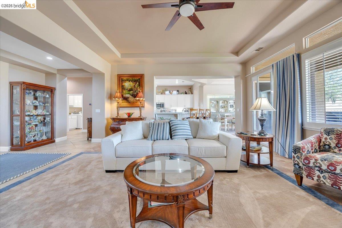 158 Rock Ridge Lane Copperopolis, CA 95228 - Photo 14 of 72 Spacious living area featuring tray ceilings with recessed lighting and a ceiling fan