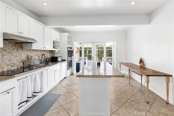 a dining room with a wooden table and chairs
