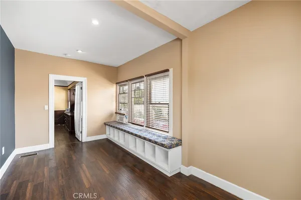 a bathroom with a granite countertop sink a toilet and a mirror