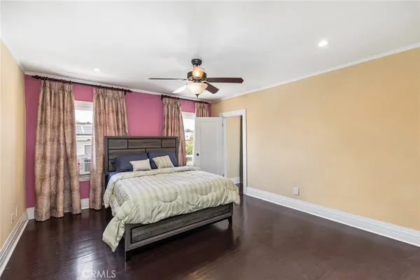 a bedroom with a large bed and a window
